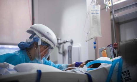 A nurse cares for a Covid patient in the intensive care unit at Prividence Cedars-Sinai Tarzana medical center in Tarzana, California. 
