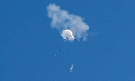 The suspected Chinese spy balloon drifts to the ocean after being shot down off the coast in Surfside Beach, South Carolina, on Saturday.