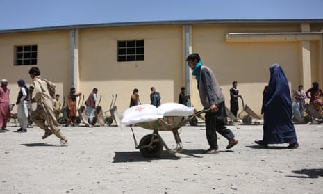 People queue to receive humanitarian assistance in Kabul last week