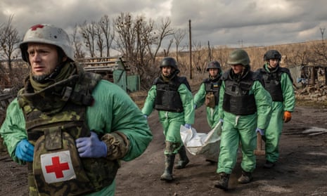 The Ukrainian volunteer group called the Black Tulip, carries the body of a Russian soldier exhumated in Krasnopillia, a deserted village in northern Donetsk.