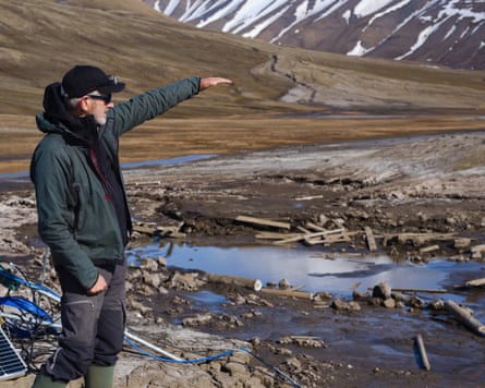 Prof Andy Hodson stands on a natural methane seep known as a ‘pingo’