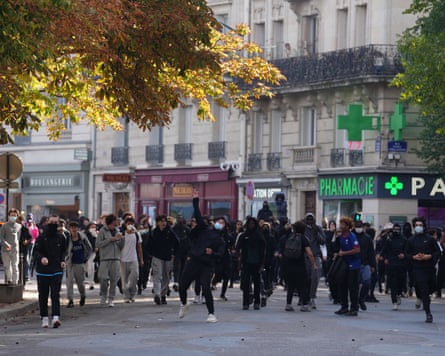 Students face policemen during a protest in Paris.