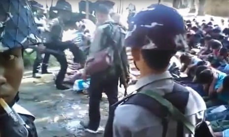 A still from a video shot by Constable Zaw Myo Htike shows a policeman kicking a Rohingya man