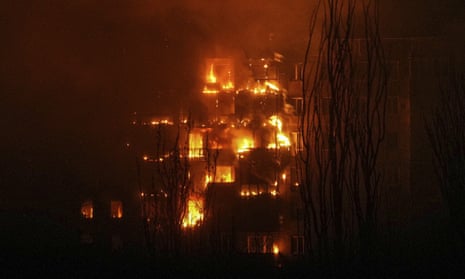 A fire burns in an apartment building after it was hit by the shelling of a residential district in Mariupol, Ukraine.