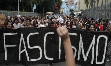 Students of the Rio de Janeiro Federal University hold a banner emblazoned with the Portuguese word for ‘Fascism’ during a protest of an electoral court order for universities to remove banners containing ‘negative propaganda’ against Jair Bolsonaro, in Rio de Janeiro, Brazil.