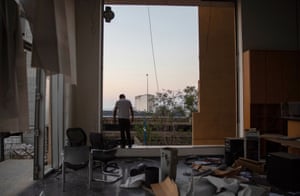 A man stands inside a damaged building at the port in Beirut, Lebanon.