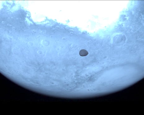 Image of Mars with relatively small space rock in front of it