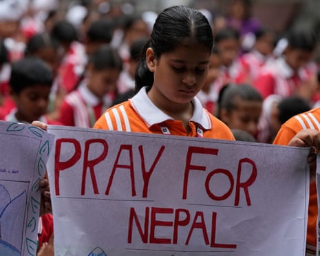 Indian school children place placards as they pray for the victims