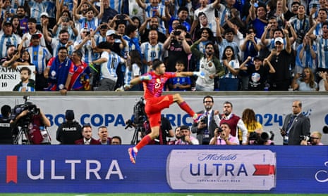 Emiliano Martinez celebrates a stop in the penalty shootout against Ecuador with Argentinian fans.