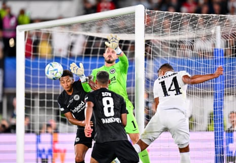 Kevin Trapp of Eintracht Frankfurt attempts to stop the ball as Casemiro of Real Madrid heads the ball to David Alaba, who scores their side's first goal.