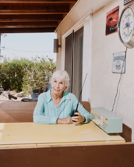 Woman holds small radio at desk