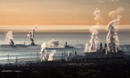 The industrial landscape across the Dee estuary at sunrise as steam rises from Deeside power station, Shotton Steelworks and other heavy industrial plants on 13 April, 2016 in Flintshire, Wales.