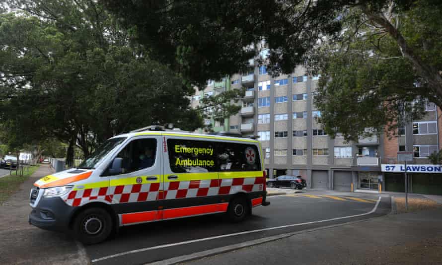A New South Wales ambulance is seen leaving a housing tower in Redfern on Thursday.