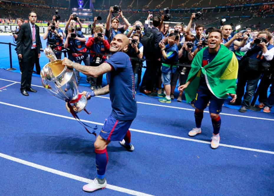 Dani Alves celebrates with the trophy after winning the Champions League with Barcelona in 2015