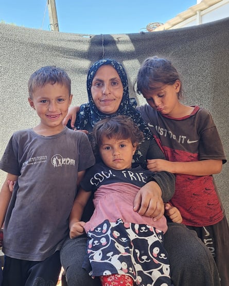 Neama al-Barawi and three of her five children in their makeshift shelter in Rafah.