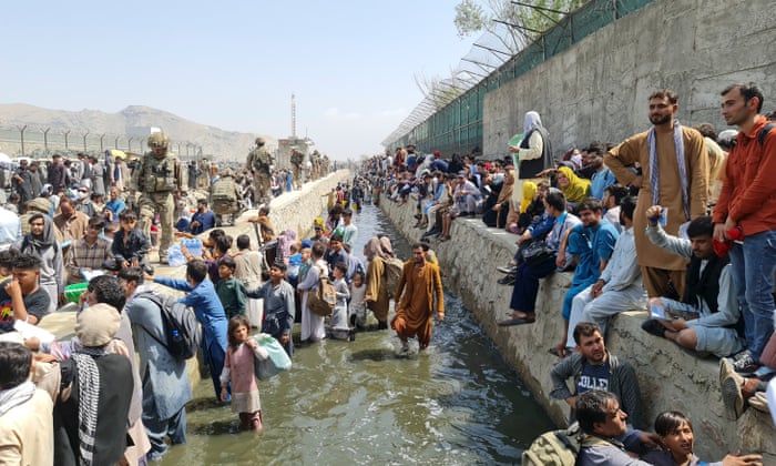Thousands of Afghans trying to evacuate Kabul are stopped by a river of raw effluent