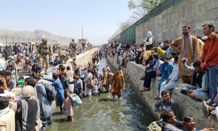 Thousands of Afghans trying to evacuate Kabul are stopped by a river of raw effluent
