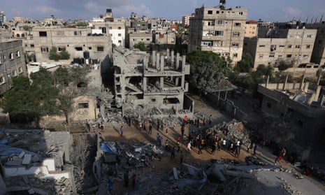 People inspect the damage after overnight Israeli strikes on Rafah in the southern Gaza Strip.