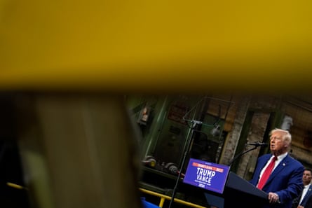 Donald Trump speaks at a campaign event in a factory