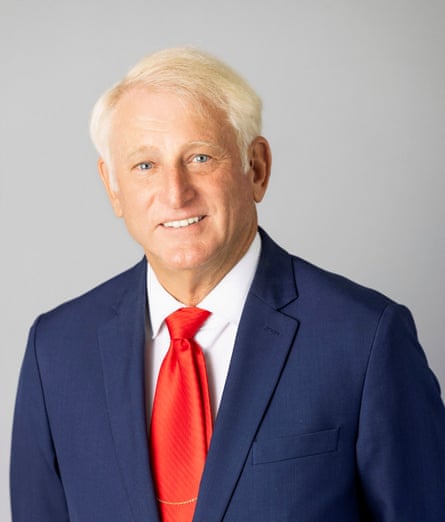 a man in a suit smiles