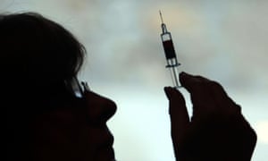 A nurse preparing to give a patient a vaccine.