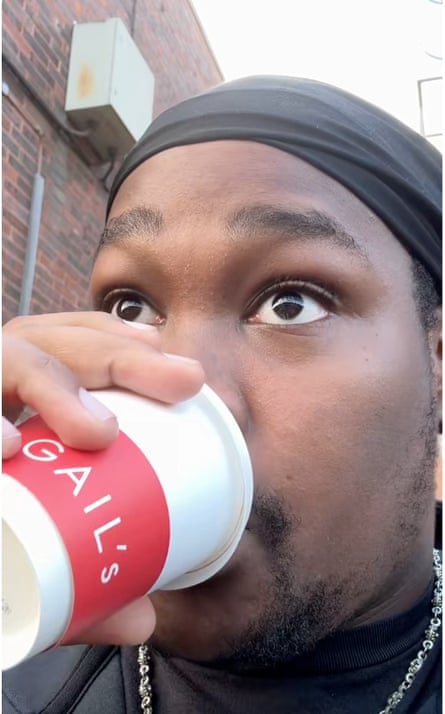 Close up of Moses Combe drinking from a Gail’s coffee cup