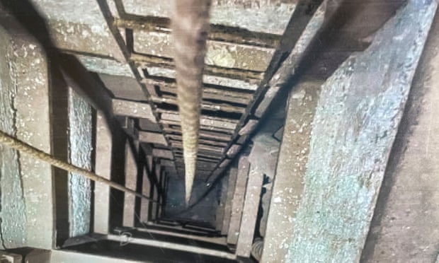 A photograph shows the inside of the tunnel between inside a warehouse in San Diego.