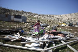 A Palestinian girl carries a toy car
