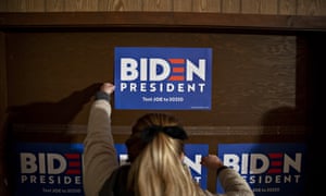 A volunteer hangs campaign signs ahead of an event in Maquoketa, Iowa, on 30 October 2019.