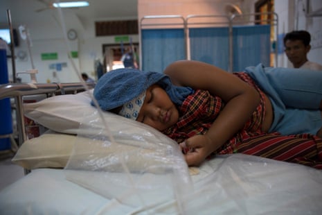 Chan Pheakdey lies in bed at Angkor hospital