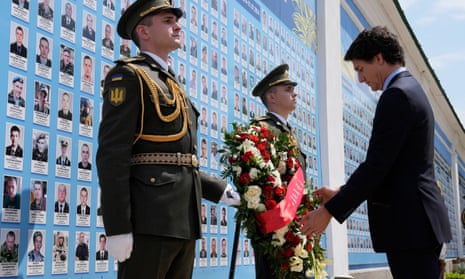Canadian prime minister, Justin Trudeau, right, lays a wreath at the memorial wall outside of St Michael’s Golden-Domed Monastery in Kyiv, Ukraine.