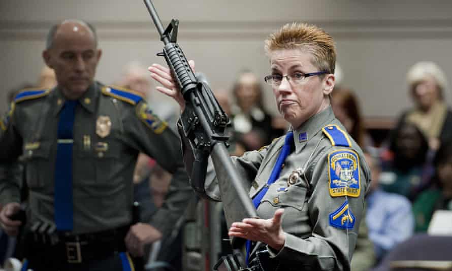Detective Barbara J Mattson of the Connecticut state police holds a Bushmaster AR-15, the make and model of gun used in the Sandy Hook School shooting.