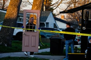 An investigator collects evidence from the scene of a fatal shooting