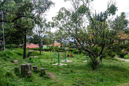 A children’s play area among trees with see-saw, etc