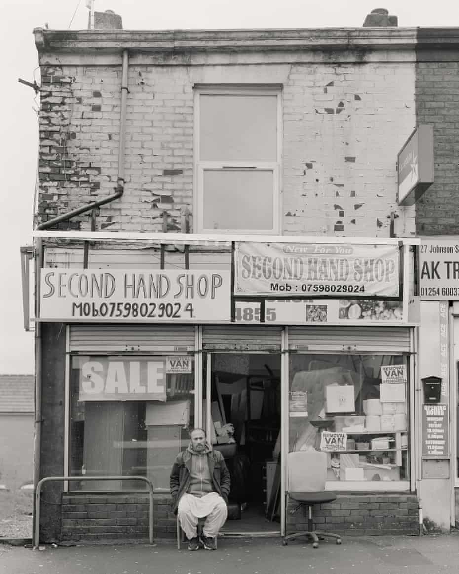 The view from Bank Top: Craig Easton’s images of life in Blackburn | Photography 3 Muhammad Ayub outside his second-hand shop on Johnson Street