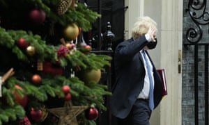 Boris Johnson walks past the Downing Street Christmas tree. (Photograph by: Matt Dunham/AP Photo)