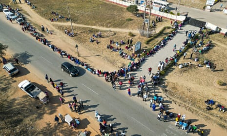 Voters queue to cast their ballots at a polling station in the Epworth suburb of Harare