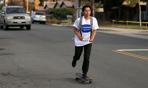 Angelina Alvarez, 16, skateboards to Newport Harbor high school in her Dump Trump shirt.