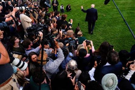 Trump speaks with reporters on the South Lawn as he departs the White House.