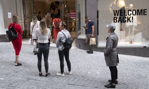 Expect queues … waiting to get into a reopened clothes shop in Switzerland.