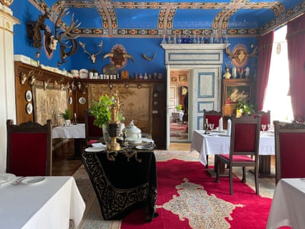 Lavish blue ceilings, frescoes and stags' heads in an ornate room