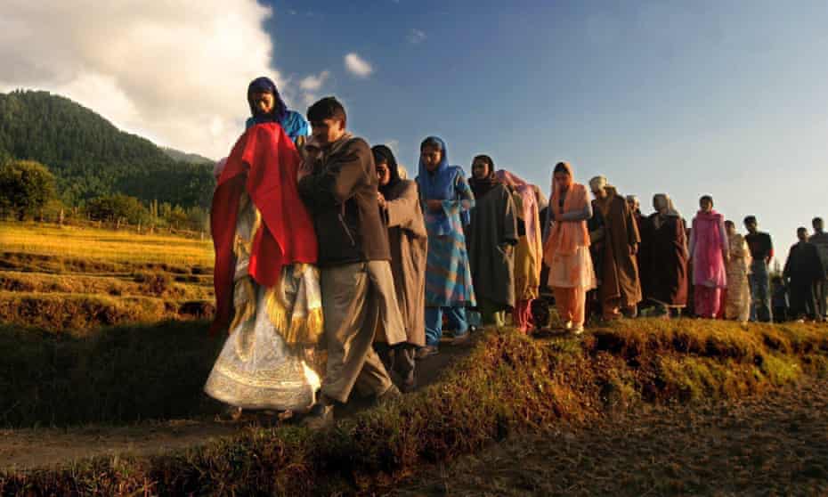 A Kashmiri bride accompanied by her relatives and friends