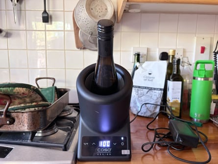 A bottle of wine in a Caso Design VinoCase tabletop wine cooler on a kitchen worktop.