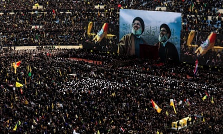 A vehicle carries the coffins of Hassan Nasrallah and Hashem Safieddine in a sports stadium in the southern suburbs of Beirut