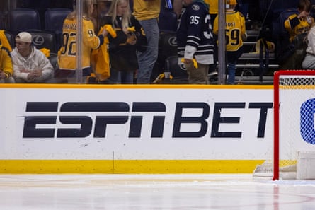 An ESPN Bet advertisement on the rink boards beside a hockey goal during a Stanley Cup playoff game