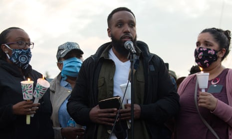Matthew Ellis speaks while holding a Bible during a vigil for his brother, Manuel Ellis, on Wednesday.