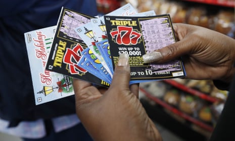 A customer shows off her set of non-winning scratch-off tickets in Jackson, Mississippi. 