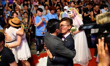 A gay couple kiss during a mass wedding banquet in front of the Presidential Palace in Taipei. Taiwan is the only country in Asia to legally recognise same sex marriage.