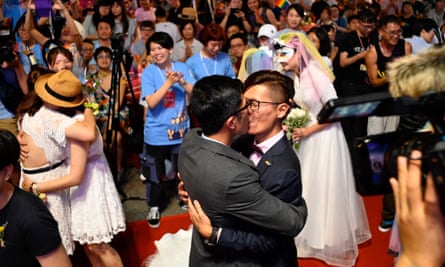 A gay couple kiss during a mass wedding banquet in front of the Presidential Palace in Taipei. Taiwan is the only country in Asia to legally recognise same sex marriage.