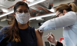 Student Minerva Ruiz receives a dose of the Pfizer BioNTech vaccine at a vaccination clinic at California State University, Dominguez Hills in Carson, California.